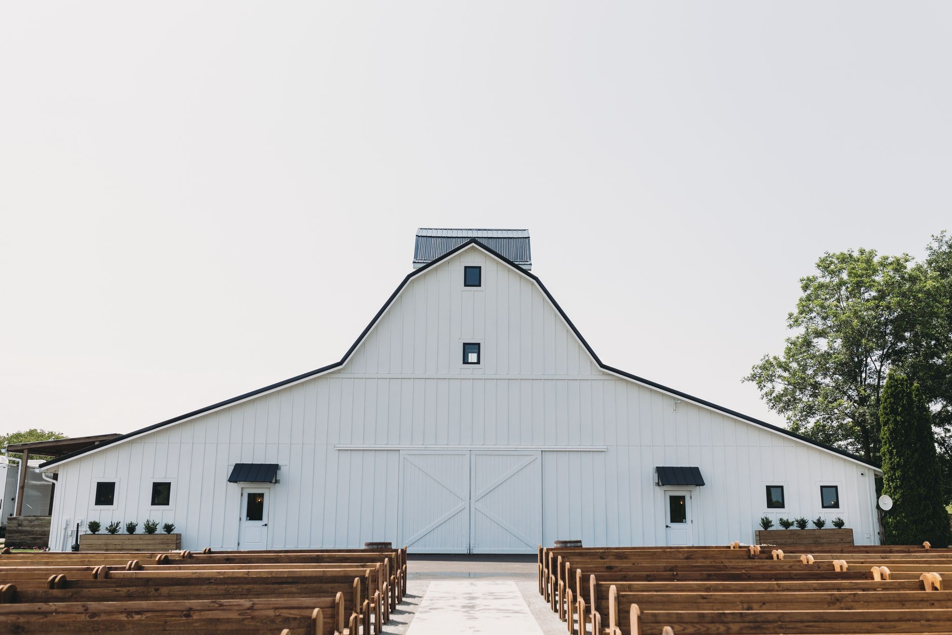 Picturesque white barn with rustic benches