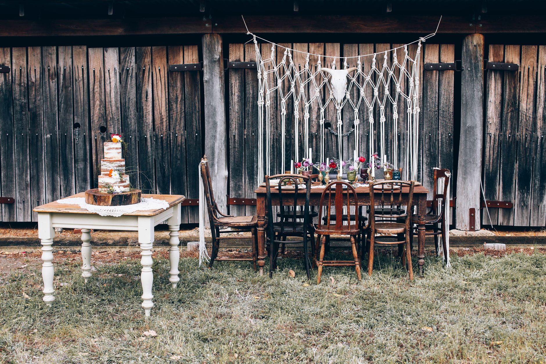 Rustic outdoor wedding setup with vintage chairs